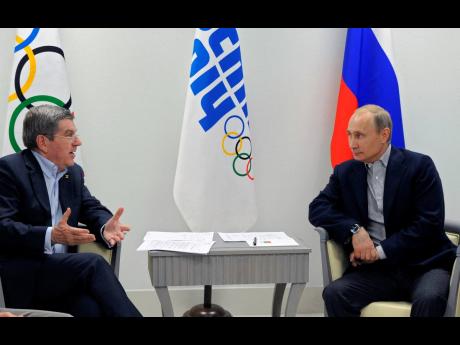 In this February 15, 2014 file photo Russian President Vladimir Putin (right) and IOC President Thomas Bach meet in the Bolshoi Ice Dome in Sochi, Russia. 