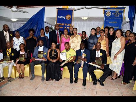 From left (seated): Osmond Robinson, Deceita Turner, Dr Kevin McIntyre, Sandra Molyneaux, president of the Rotary Club of Savanna-la-Mar, Caniel Scott, Desmond Malcolm, and Angel James. Others sharing the spotlight are members of the club and their guests.