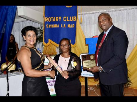 Deceita Turner (centre), collects her community development award from Sandra Molyneaux (left), president of the Rotary Club of Savanna-la-Mar and Demerce Guscott, president-elect of the club.