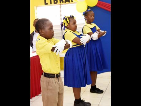 Members of the Old Harbour Primary school Sign Language Club, perform during the handing over ceremony.