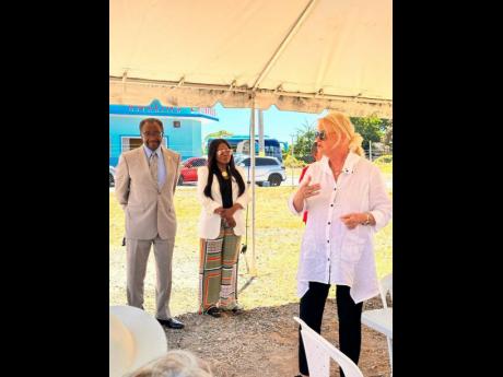 From left: US Ambassador to Jamaica Noah Nickolas Perry; Consul General Alison Roach Wilson and Michele Rollins, chairman, Rose Town Foundation, in Rose Town last Friday on a tour of the area.
