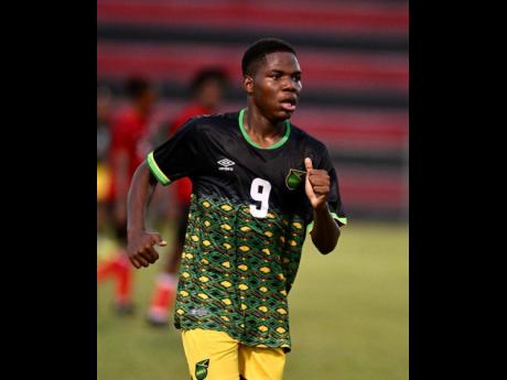 Orane Watson celebrates after scoring Jamaica’s opening goal in their under-17 practice match against Trinidad and Tobago at the Anthony Spaulding Sports Complex today.