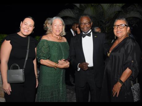 From left, the lovely Alex Clarke rocked a Brandon Blackwood ‘End Systematic Racism’ tote with mum Monica Ladd, United States Ambassador to Jamaica, Nick Perry and Ruth Jankee, executive director of Rose Town Foundation by her side.