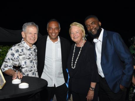 From left, Edward Waxer, President for World Sports Inc shares lens time with Andre Virtue, director at Ballaz International Group, Michele Rollins, chairman of Rose Hall Developments Ltd and Sean Williams, competitions director of Youth Football League.