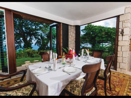 The dining room opening to gardens and sea views, whets your appetite.