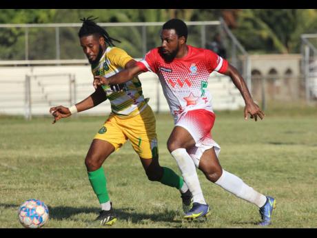 Vere United’s goalscorer Lamard Neil (left) gets by Harbour View’s Demar Rose during their Jamaica Premier League encounter at the Wembley Centre of Excellence yesterday. Vere United won the game 1-0.