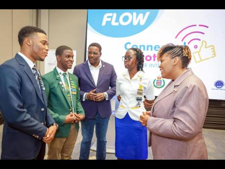  Flow vice president and general manager, Stephen Price (centre), and president of the Jamaica Teachers’ Association, LaSonja Harrison (right), listen keenly during their discussion with representatives from the National Secondary Students’ Council (NS