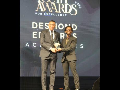 Desmond Edwards receives his award for academic excellence.