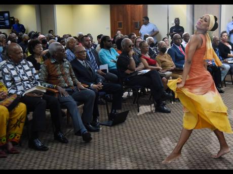 Kerry-Ann Henry, ballet mistress with the National Dance Theatre Company, performs for the audience at the Inaugural Rex Nettleford Distinguished Lecture at The UWI, Mona, on Friday.