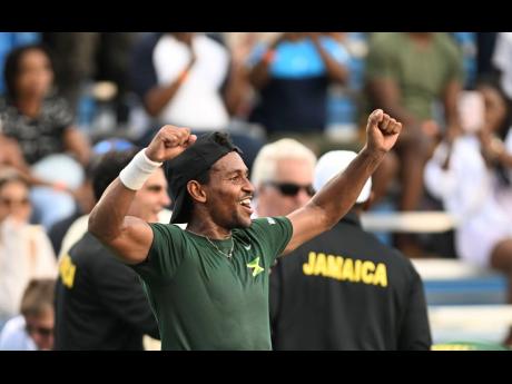 Jamaica’s Rowland Phillips celebrates with the crowd at the Eric Bell Tennis Centre on Saturday after he dismissed Estonia’s Kristjan Tamm, 6-1, 6-1, in Davis Cup Group II qualification action.