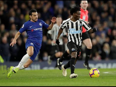 Chelsea’s Pedro (left) and Newcastle United’s Christian Atsu vie for the ball during an English Premier League football match between the teams at Stamford Bridge stadium in London in 2019.