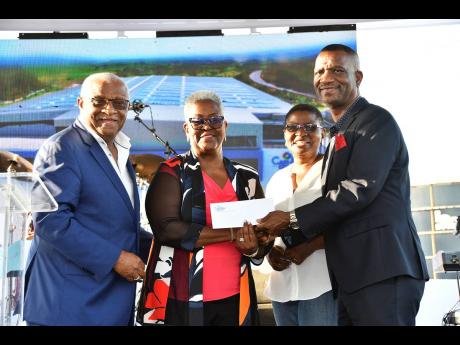 Founders of the Cari-Med Group, Glen and Marva Christian, present their personal pledge of US$1 million to Dr Asburn Pinnock (right), president of The Mico University College, and Lorraine Jones (second right), secretary of the Jamaica STEM for Growth Foun