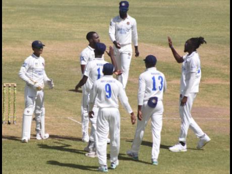 Barbados Pride players celebrate the wicket of Jamaica Scorpions opener Leroy Lugg on day one of their second-round West Indies Championship match at the Coolidge Cricket Ground in Antigua yesterday.