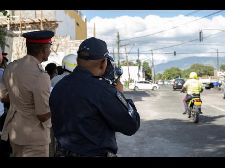 Police conduct a training exercise with members of the Island Traffic Authority on Elletson Road in Kingston in January. 