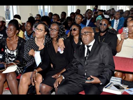 Family friends Thora Gordon (left) and Sonia Sterling (second left) support parents Jennifer and Horace Hines at the thanksgiving service for the late Diego Hines at Falmouth Seventh-day Adventist Church on Sunday.