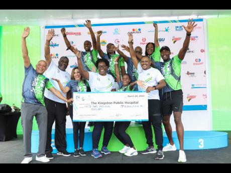  Sagicor executives and representatives from the Kingston Public Hospital (KPH) celebrate the $52 million raised for the hospital’s surgery department from the 2022 Sagicor Sigma Corporate Run. KPH was the sole beneficiary of the run and received medical