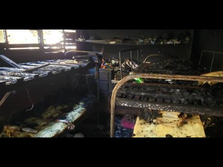 Charred beds in the dormitory of Westwood High School after a tablet, which got overheated while charging, set off a fire.