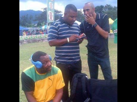 Eldemire Smith (left)  with coach Reynaldo Walcott (centre) and St Elizabeth Technical High principal Keith Wellington at the 2016 Western Relays in Montego Bay. 