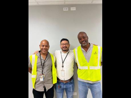 COO Carlos Cabrera (centre) shares a photo with Kaneil McKenzie (left) and Anthony Davis (right) hours ahead of their departure to Nigeria.