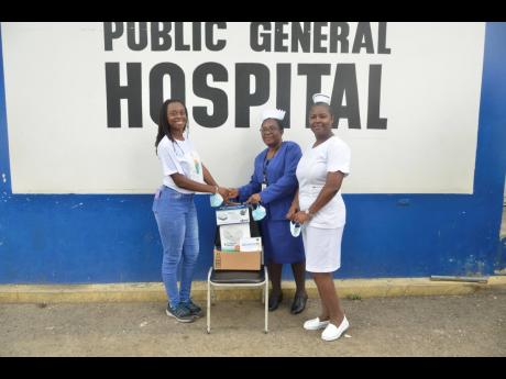 University of Technology student, Geri-Ann Miller (left), hands over a donation of three nebulisers to Director of Nursing Services at the Savanna-la-Mar Public General Hospital, Hazeline Forrester (centre), and nurse, Sophia Thomas, at the hospital on Feb