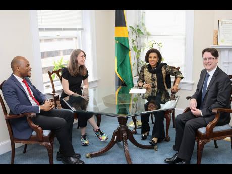 Jamaica’s Ambassador to the United States, Audrey Marks, shares a light moment with the senior director of Strategic Planning & Airline Partnerships for Southwest Airlines, Steven Swan (right), as he, along with the senior manager for Governmental Affair
