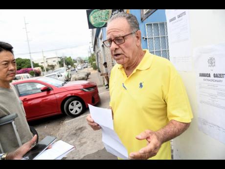Property owner Ray Brennan (right) and businessman Larry Kong speak to journalists about land acquisition plans along Lady Musgrave Road on Thursday. 