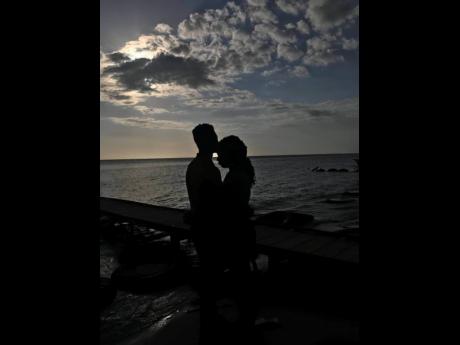  Jeremy Anderson kisses Jheanelle Pinnock on the forehead as the two take in the sunset.