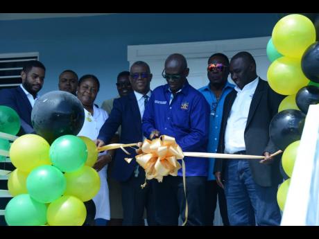 Minister of Local Government and Rural Development Desmond McKenzie (third right) officially opens the new $45-million male ward at the St James Infirmary in Albion, Montego Bay, on February 15. He is joined by mayor of Montego Bay and chairman of the St J