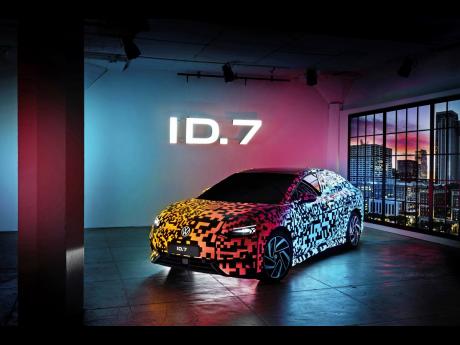 This photo provided by Volkswagen shows the Volkswagen ID.7, the brand’s first electric sedan. It is shown here with a bespoke multicolor paint job that can be illuminated at night.