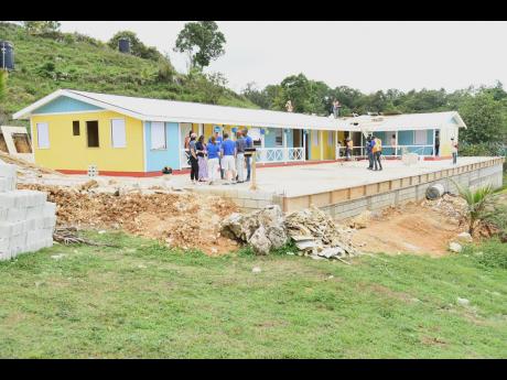 Workmen applying the finishing touches to the new building that will accommodate 70 students in the infant department at the Content Primary and Infant School in Westmoreland.
  