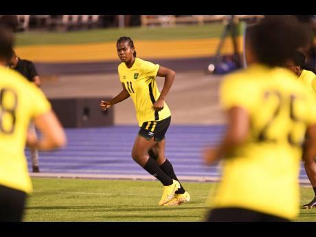 Reggae Girlz captain Khadija Shaw (centre) makes a move off the ball during a practice session at the National Stadium late last year.
