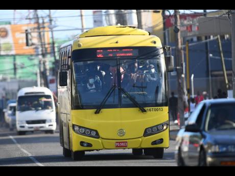 A Jamaica Urban Transit Company bus transports passengers along Half-Way Tree Road, St Andrew.