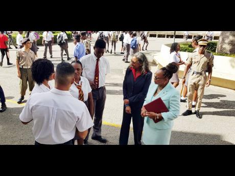 left; Principal of Harrison College, Juanita Wade (right) and principal of Campion College, Grace Baston (2nd right) are in conversation with (from left) head boy of Campion College, Matthew Wilmot; head girl of Campion College, Breanna Burke; head girl of