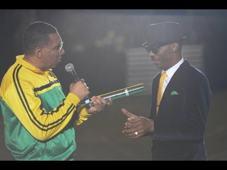 Prime Minister Andrew Holness makes the Reggae Icon presentation to Sanchez on Independence Day 2022 at the National Stadium.