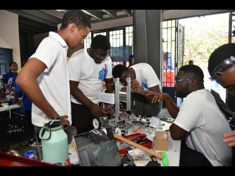 The St George’s College team preparing their robot before the start of the competition on Saturday.