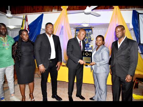 From left: Constable Anthony Richards, Woman Constable Krystal Cox, Deputy Superintendent of Police Adrian Hamilton, Senior Superintendent of Police Wayne Josephs, commanding officer of the Westmoreland Police Division, are presented by president of the Ki