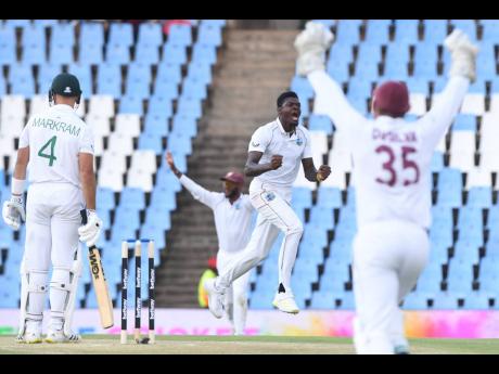 West Indies pacer Alzarri Joseph (second right) celebrates the wicket of opener Dean Elgar on day two of the team’s first Test against South Africa at SuperSport Park in Centurion yesterday.