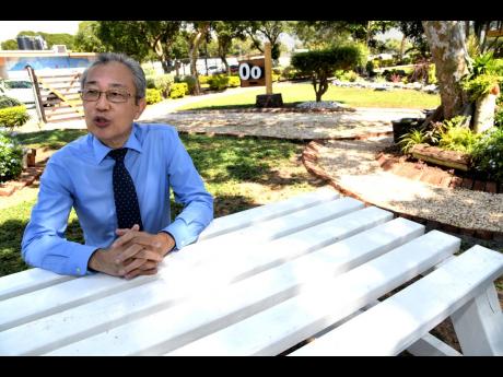 Bellevue Hospital Senior Medical Officer Dr Myo Kyaw Oo reflecting on his career inside the park dedicated in his honour at the Kingston-based psychiatric facility on Monday.