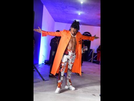 Recording artiste, D’Yani, closes the show sporting this fire orange longline combat jacket and Nami combat pants.