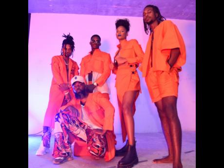 Fire orange has never looked so good! Fashion designer, stylist and creative director of Tribe Nine Studios Troy Oraine Williamson (front and centre)  strikes a pose with fellow creatives, rocking pieces from his Horizon collection.