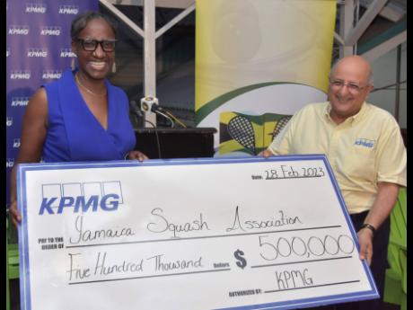  President of the Jamaica Squash Association Karen Anderson (left) receives a cheque valued at $500,000 from Tarun Handa (right), senior partner at title sponsors KPMG, at Tuesday’s launch of the 2023 KPMG Squash League at the Liguanea Club in Kingston.
