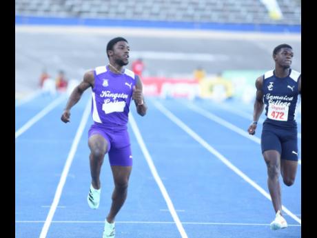Bouwahjgie Nkrumie (left) of Kingston College wins the Class One boys’ 100 metres in 10.32 seconds  at the  Corporate Area Championships yesterday. Jamaica College’s Jadien Reid (right) was second in 10.51. The two-day meet ends today at the National S