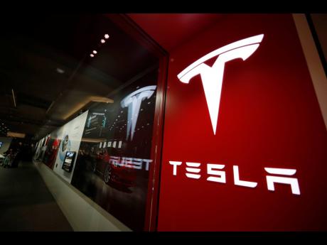 AP PHOTOS
FILE – A sign bearing the Tesla company logo is displayed outside a Tesla store in Cherry Creek Mall in Denver, Colorado, February 9, 2019. Mexico is undergoing competition among several states in 2023 to attract a possible Tesla facility. 