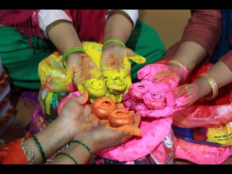 A family mixes coloured powder ahead of the festival of Holi in the northern Indian city of Jaipur.