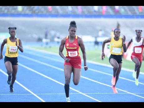 
Wolmer’s Girls’ School’s Makayla Gardener on her way to winning the girls Class One 100 metres at the Corporate Area Development meet inside the National Stadium on Friday.