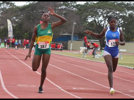 Tiana Oliver (left) of Vere Technical High wins the Class Three girls’ 100 metres final in 12.27 seconds at last week’s Central Athletics Champs ahead of Acheelah White of St Catherine High, 12.32.