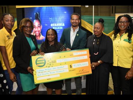 President of Netball Jamaica, Tricia Robinson (third left), Sunshine Girl Shanice Beckford (left), and coach Connie Francis (right) pose with a symbolic cheque of $15 million from Seprod along with (from left) the organisation’s head of supply chain, Mar