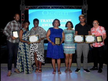 Tanesha Clarke (centre), director of sales and marketing, Ocean Coral Spring and Ocean Eden Bay, is photographed with the top three awardees in sales production overall at the Annual  Local Travel Agency Awards held at Ocean Eden Bay on Wednesday, March 1.