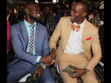  National leadership nominees Andrew Johnson  (left) and Kevar Bennett congratulate each other during the recent Prime Minister’s National Youth Awards for Excellence awards ceremony on the lawns of Jamaica House in St Andrew. 