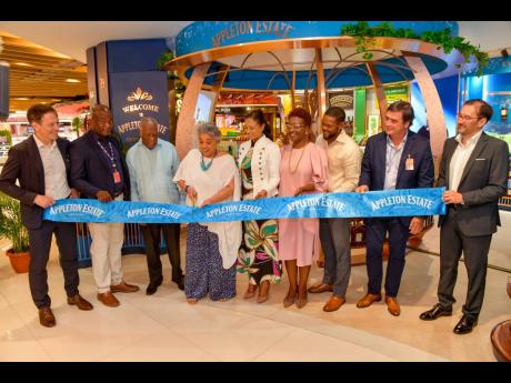 Master Blender Dr Joy Spence (fourth left) cuts the ribbon officially unveiling the first Appleton Boutique in the Sangster International Airport. She is joined (from left) Campari Group Brand Premiumization Managing Director, Jean Jacques-Dubau; MBJ Airpo